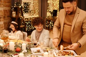 A nesting party for new parents. A joyful family gathered for a festive Christmas dinner indoors, surrounded by decorations. Nesting parties.